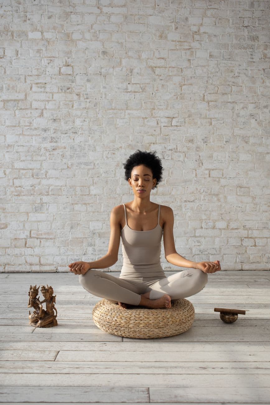 Woman meditating in a bright minimalist room